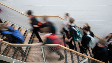 Blurred pupils rushing moving in the hallway corridor of a secondary comprehensive school, Wales UK