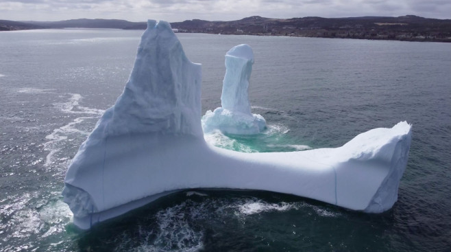 EXCLUSIVE: VIDEO: Huge WILLY-shaped ICEBERG floats past town called DILDO