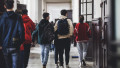 Bucharest, Romania - April 11, 2022: High school students in the hallway of a Bucharest old high school during break.