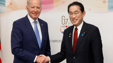 US President Joe Biden (left) and Fumio Kishida (R) Japan's Prime Minister shake hands