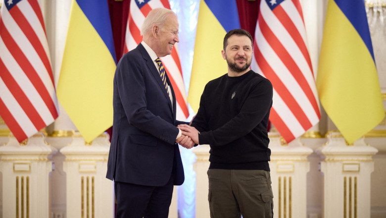 Președintele SUA Joe Biden îi strânge mâna președintelui Ucrainei Volodimir Zelenski la Kiev, pe 20 februarie 2023.