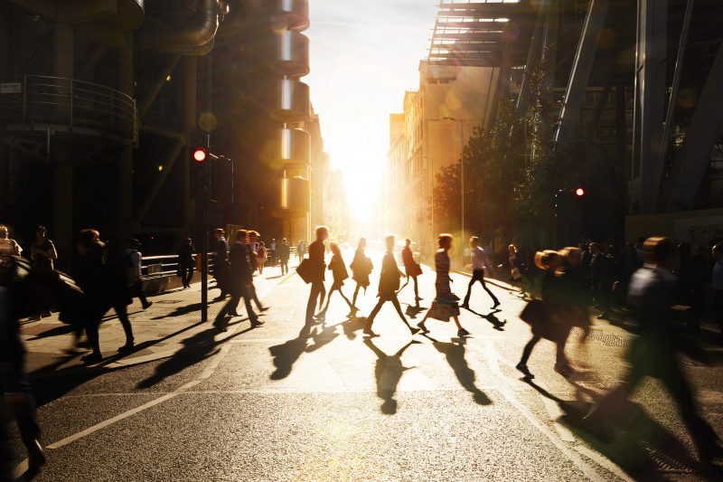 Business people walking through at city at dawn.