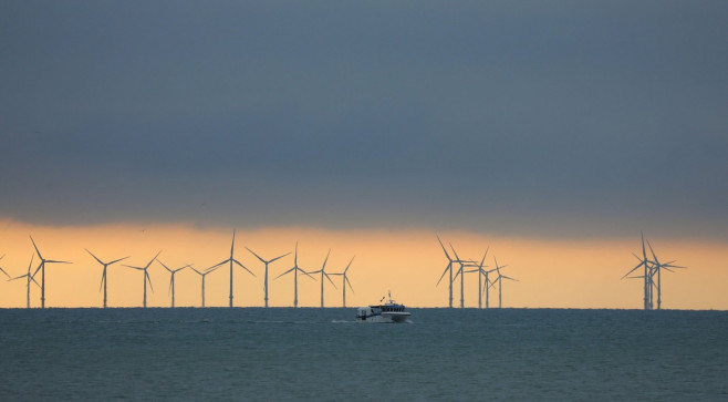 Hove, UK. 26th Nov, 2020. The Rampion Offshore Wind Farm is seen in the distance as the light begins to fade off the Sussex coast. Credit: James Boardman/Alamy Live News