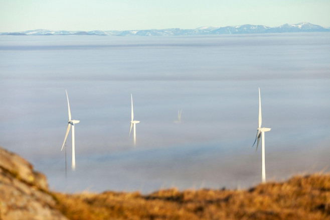 Wind turbines sticking out of clouds caused by a temperature inversion in the Ochil Hills Scotland