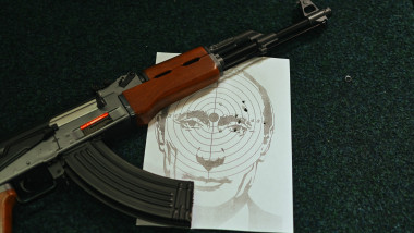 dummy AK-47 on a table with a target representing Vladimir Putin's