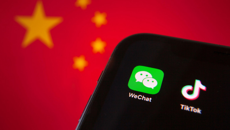 Cellphone with WeChat and TikTok icons in front of the flag of China. USA president Donald Trump bans apps of China due to the national security