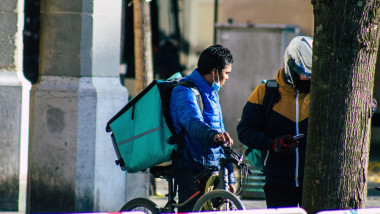 Reims France October 31, 2020 View of food home delivery people working in downtown during the Coronavirus pandemic affecting France and this in order