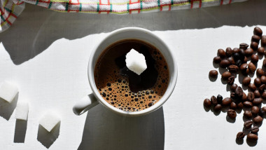 Falling sugar into a warm drink Coffee