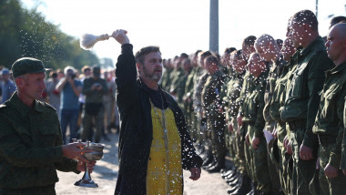 Orthodox priest blesses men conscripted for military service before their leaving for additional training, in the Volgograd region, Russia