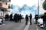 jandarmi francezi în fața unui nor de gaze lacrimogene