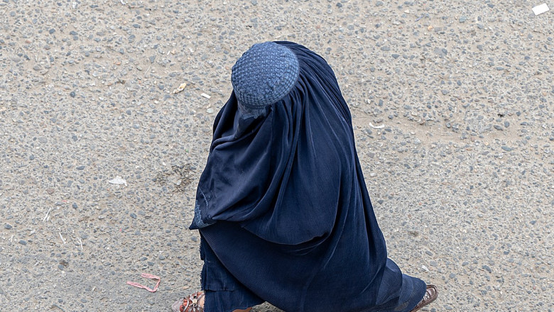 O femeie din Afganistan care poartă burka se plimbă pe o stradă din Kabul, pe 25 aprilie 2023.