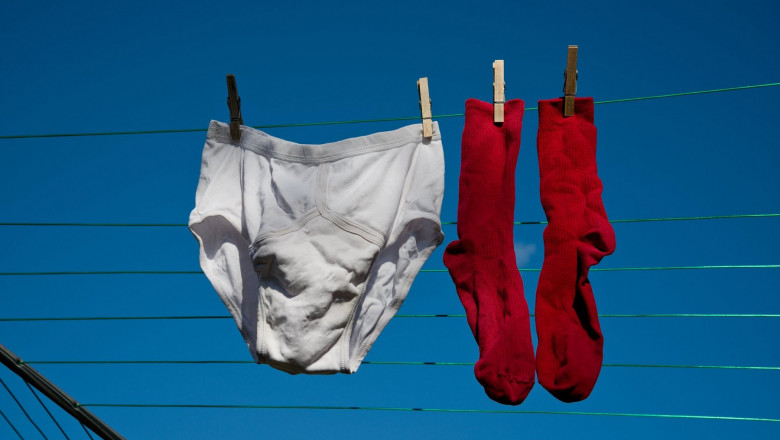 Washed clothes hanging out to dry on a washing line. Male underwear. Pants and socks.