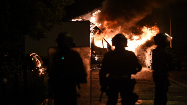 Polițiști privesc spre un incendiu în Franța