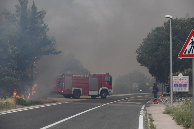 Croatia, Sibenik, 130723. Firefighters and airtankers are putting out the fire that broke out this morning in the villag