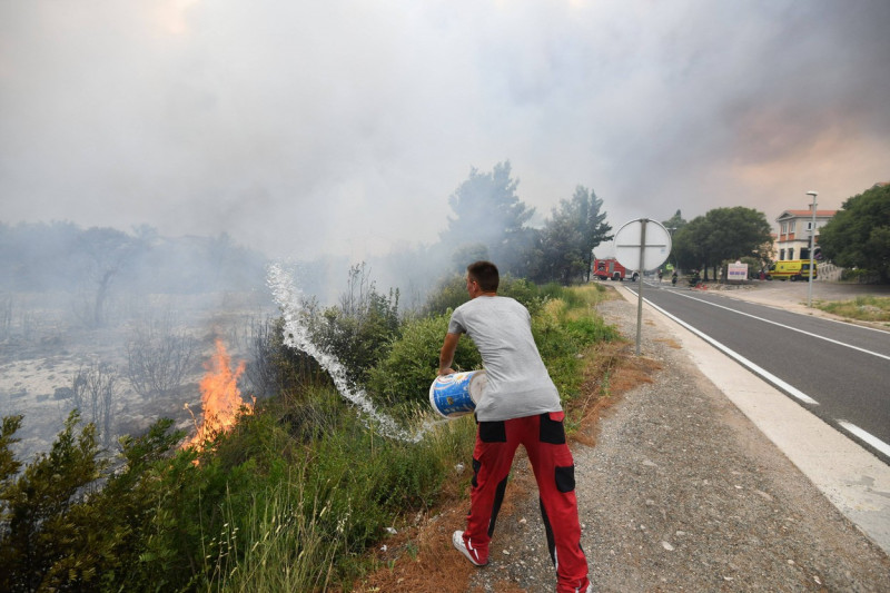 Croatia, Sibenik, 130723. Firefighters and airtankers are putting out the fire that broke out this morning in the villag