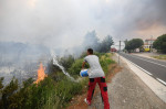 Croatia, Sibenik, 130723. Firefighters and airtankers are putting out the fire that broke out this morning in the villag