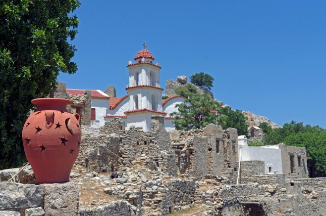 Agia Zoni Church, Mikro Horio, Tilos, Dodecanese islands, Southern Aegean, Greece; with pretty terracotta urn in foreground. Tilos, Greece
