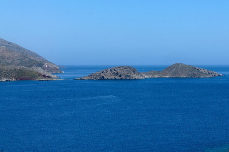 Small islet (Gaidaros) just off Tilos island Dodecanese, Greece, EU.cym