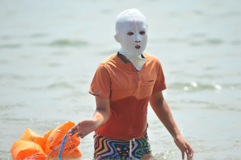Women wear 'facekini' masks, Qingdao City, China - 17 Aug 2016