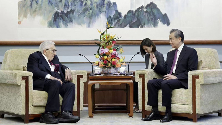 Director of the Office of the Foreign Affairs Commission of the Communist Party of China's Central Committee Wang Yi (R) speaking with former US secretary of state Henry Kissinger (L)