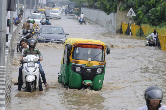 GURUGRAM, INDIA - JULY 9: Vehicle wades through a waterlogged stretch after heavy monsoon rains at sohna road near Islam