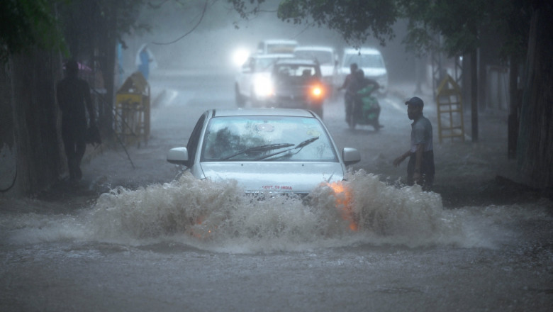 NEW DELHI, INDIA - JULY 9: Vehicles wade through a Waterlogged stretch under a railway bridge near Sarojini Nagar during