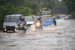 NEW DELHI, INDIA - JULY 9: Commuters seen moving through water logged street after heavy rains at Bhairav Marg on July 9