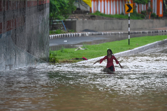 NEW DELHI, INDIA - JULY 9: Commuters moves from heavily water logged Bhairav Marg underpass after monsoon rains on July