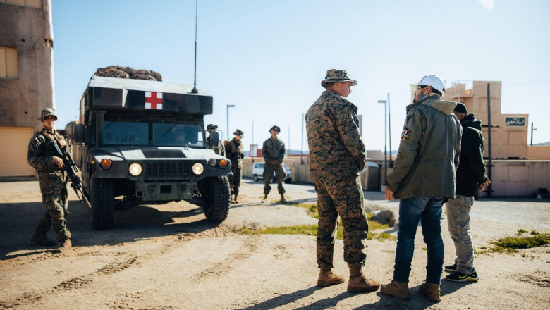 U.S. Marines with 3d Marine Littoral Regiment, 3d Marine Division talk with role players acting as civilians of a simulated town during Marine Littoral Regiment Training Exercise (MLR-TE) at Marine Corps Base Camp Pendleton, California, Feb. 15, 2023. MLR