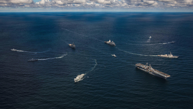 Baltic Sea, International Waters. 30 August, 2022. The U.S. Navy Wasp-class amphibious assault ship USS Kearsarge, right, leads a break-away maneuver with ships from the Swedish Navy during a NATO maneuvering exercise, August 30, 2022 in the Baltic Sea.