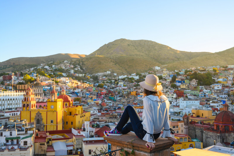 Woman admiring Guanajuato city and the basilica, Guanajuato, Mexico