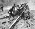 US Army artillery crew firing a 105 millimetre howitzer, during the Korean War 1950