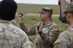 U.S. Army Sgt. 1st Class Jeremy Garduno, assigned to Palehorse Troop, 4th Squadron, 2nd Cavalry Regiment, demonstrates the capabilities of the PD-100 Black Hornet Nano Drone to fellow Soldiers during a situational training exercise at the 7th Army Trainin