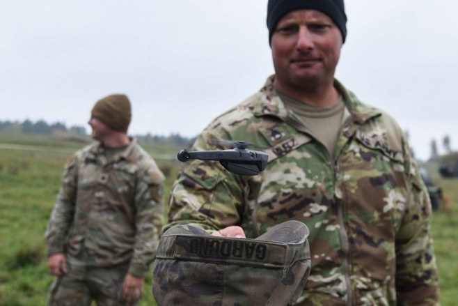 U.S. Army Staff Sgt. Jamie Mutz, assigned to Palehorse Troop, 4th Squadron, 2nd Cavalry Regiment, prepares to catch a PD-100 Black Hornet Nano Drone during a situational training exercise at the 7th Army Training Command's Grafenwoehr Training Area, Germa