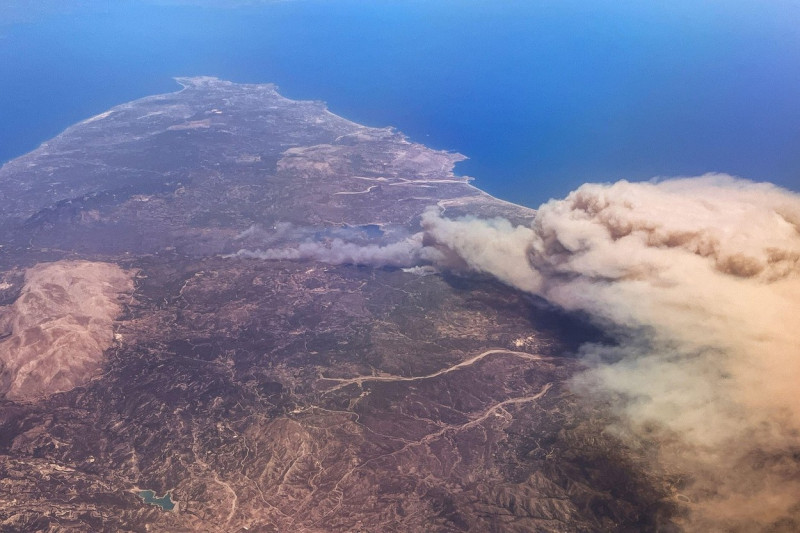 Rhodos, Greece. 22nd July, 2023. Forest fires rage on the vacation island of Rhodes (photo taken from an airplane). According to meteorologists, the heat wave will continue next week with minor fluctuations. On Wednesday, a new peak is expected with tempe