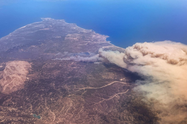 Rhodos, Greece. 22nd July, 2023. Forest fires rage on the vacation island of Rhodes (photo taken from an airplane). According to meteorologists, the heat wave will continue next week with minor fluctuations. On Wednesday, a new peak is expected with tempe