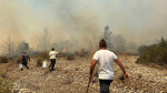 Residents help to extinguish a fire spreading in the central part of the Greek island of Rhodes, on July 25, 2023. (CTK Photo/Pavel Nemecek)