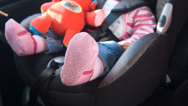 Baby girl sitting in child s car seat