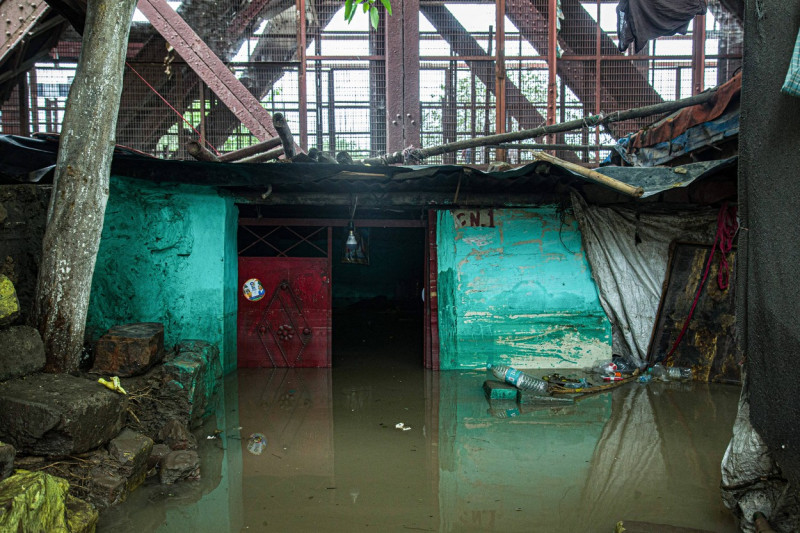 Flood in New Delhi, India A Surreal Scene: Captured in this poignant image is a house standing resiliently, partially su