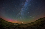 A composite showing about three dozen Perseid meteors accumulated over 3 hours of time, compressed into one image showing the radiant point of the met