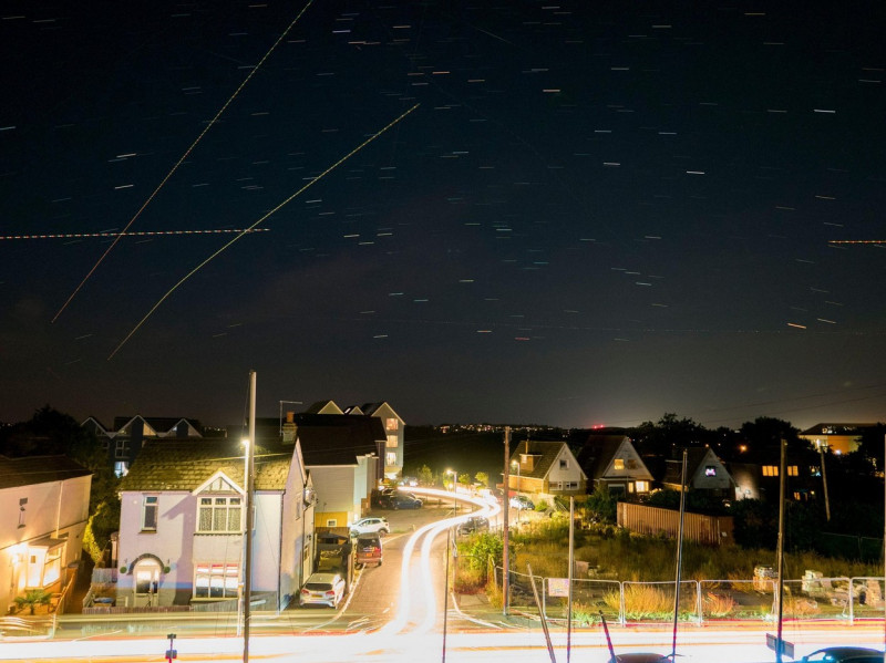 Sheerness, Kent, UK. 13th Aug, 2022. UK Weather: plane and star trails seen in the night sky above Sheerness, Kent during the annual Perseids meteor shower. Credit: James Bell/Alamy Live News