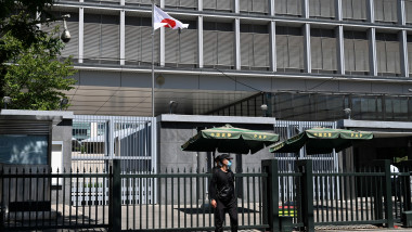 Police and security personnel stand outside the entrance of the Japanese embassy in Beijing