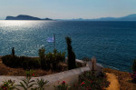 Hydra, Greece. 24th July, 2020. A Greek flag is waving in the wind. The island of Hydra, which covers almost 50 square kilometres, is 65 kilometres south-west of Athens. Cars, neon signs and plastic chairs are prohibited on the island. Credit: Angelos Tzo