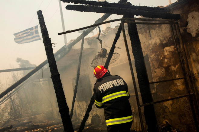 Gennadi, Greece. 24th July, 2023. Romanian firefighters try to extinguish a fire that broke out in a house near the village of Gennadi. Forest fires rage in Rhodes and other parts of Greece. Credit: Socrates Baltagiannis/dpa/Alamy Live News