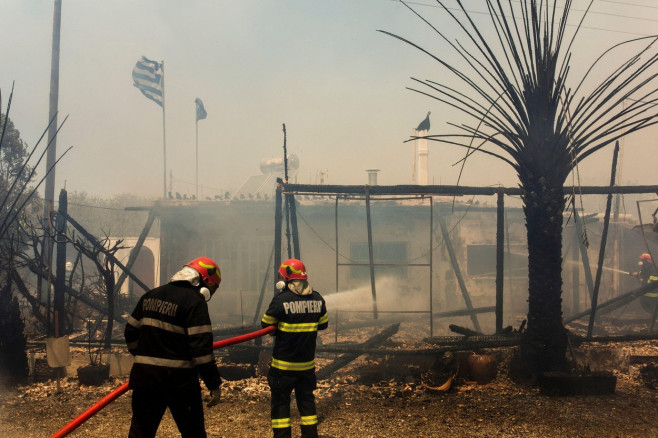 Gennadi, Greece. 24th July, 2023. Romanian firefighters try to extinguish a fire that broke out in a house near the village of Gennadi. Forest fires rage in Rhodes and other parts of Greece. Credit: Socrates Baltagiannis/dpa/Alamy Live News