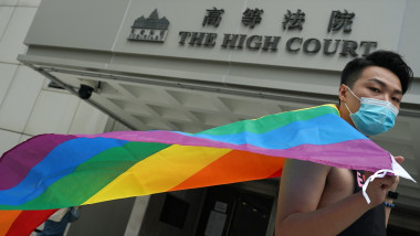 Member of Rainbow Action Jimmy Sham Tsz-kit poses for a photo with the rainbow flag at the High Court in Admiralty Hong Kong