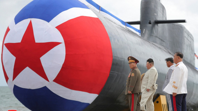 Jong Un (2nd R) attending the unveiling ceremony of the new submarine No. 841, named the Hero Kim Kun Ok,