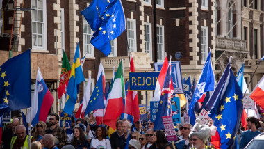 Protestors march with large flags and placards during The National Rejoin March in London