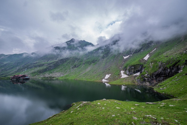 Aerial view of glacier Balea Lake next to Transfagarasan Road in Fagaras Mountains (part of Carpathian Mountains), Romania