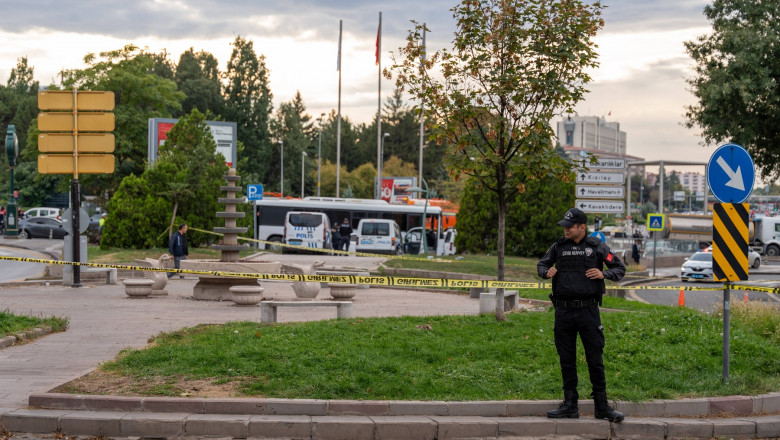A police officer stands on guard in front of the Ministry of Internal Affairs in Ankara, where the bomb attack took place